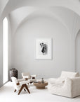 ‘Rose Mallow’ – black and white art print presented in a white frame, shown in a minimalist living room.