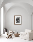 ‘Flame of the Woods' – a black and white art print presented in a walnut frame, shown in a minimalist living room.
