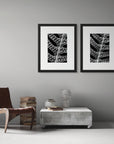 Two black and white art prints, including ‘Sorus’ and 'Sori', presented in black frames, shown on a study wall.