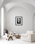 ‘Serenity Feather’ – black and white art print presented in a black frame, shown in a minimalist living room.
